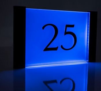 The Aspire LED lit number sign is an elegant and simplistic designer sign incorporating a specialist 8mm thick acrylic face plate complemented with a brushed aluminium backing. This classic looking beautifully made LED house number sign includes 3D raised numerals. 