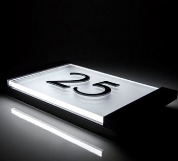 The Aspire LED lit number sign is an elegant and simplistic designer sign incorporating a specialist 8mm thick acrylic face plate complemented with a brushed aluminium backing. This classic looking beautifully made LED house number sign includes 3D raised numerals. 