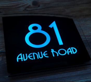 Gloss black led sign with bright blue illuminated house numbers and street name. The Sirius LED house sign range isn