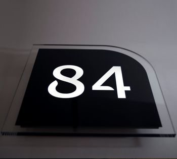 High gloss black LED sign with bright white house number illumination. Elevate your home