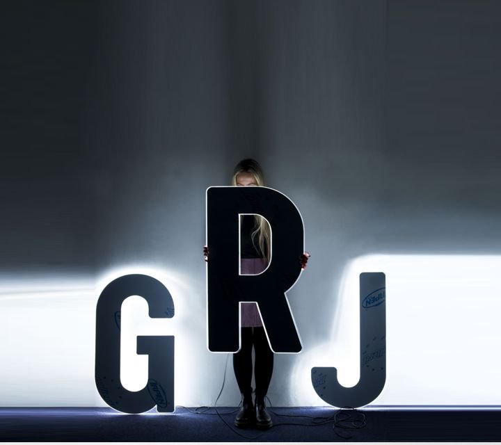 Marie hiding behind large LED numbers